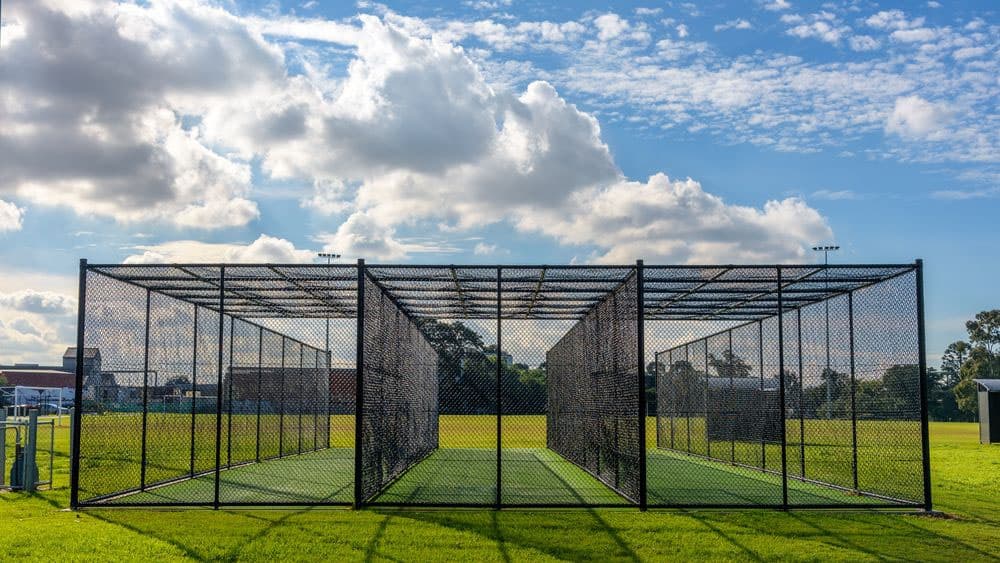 Cricket practice sports net cages on outdoor field