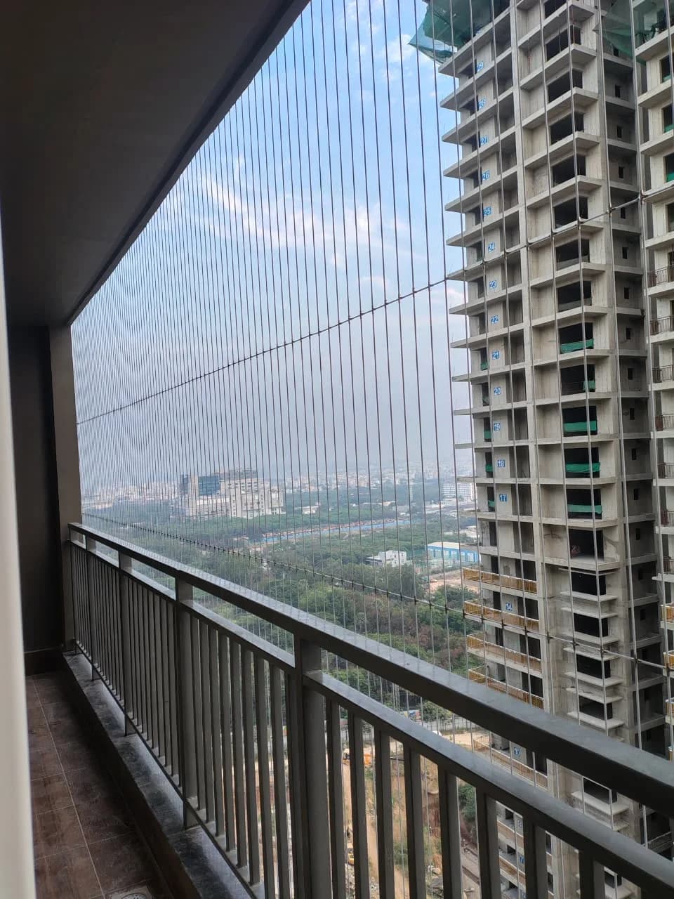 Close detail of balcony safety net mesh and edge fixing