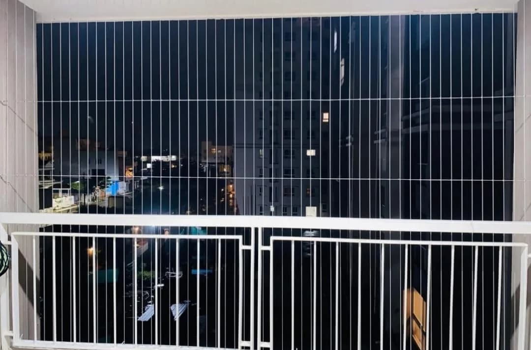 White balcony safety net overlooking palm trees